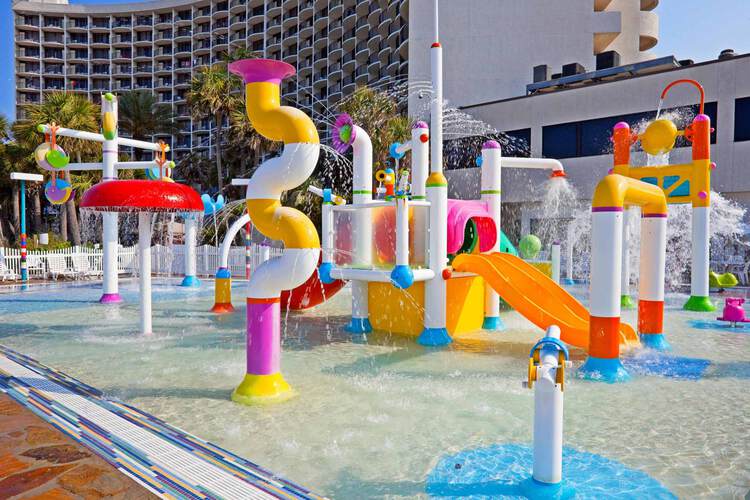 Colorful water playground with slide and multiple water apparatuses 