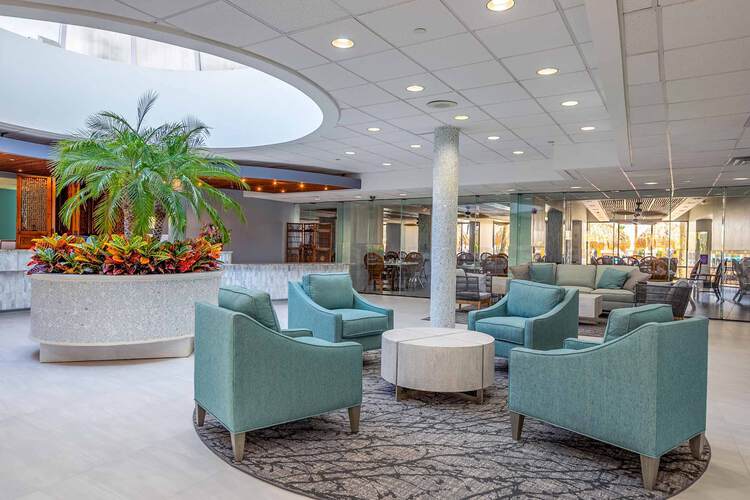 Blue armchairs in open-concept lobby space