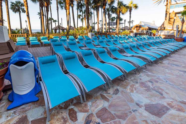 Four rows of blue lounge chairs on pool deck