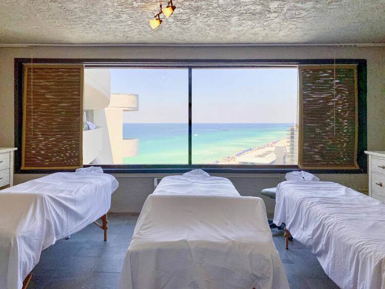 Three massage tables overlooking ocean view