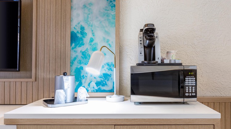 Microwave and coffee machine on side table