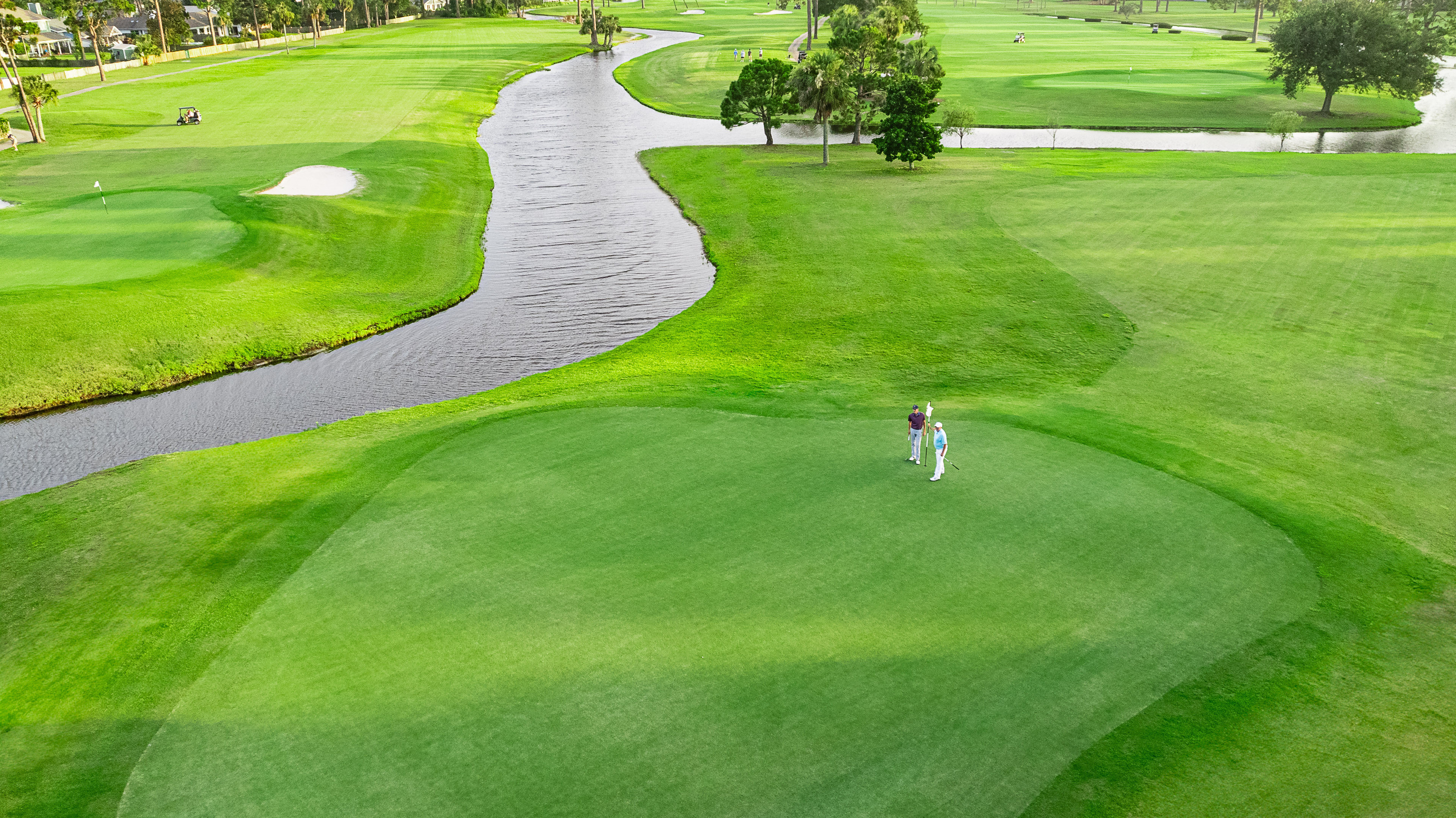 Two golfers on the green at the Legacy Golf Cub