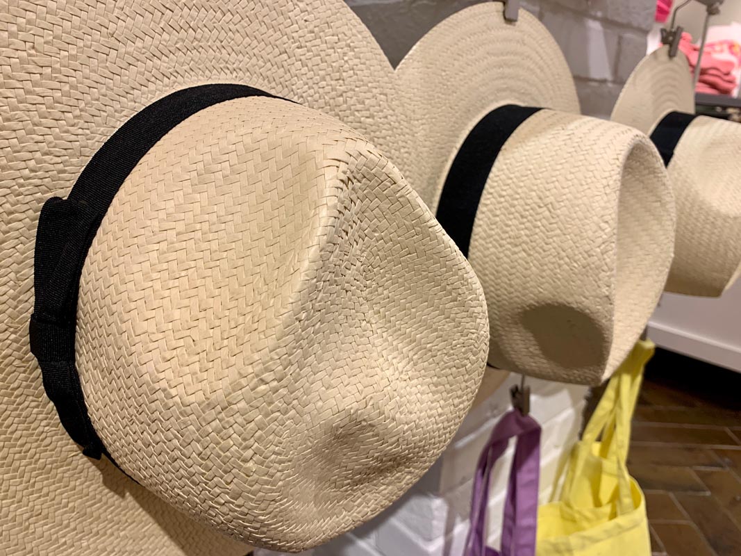 Straw hats on hooks